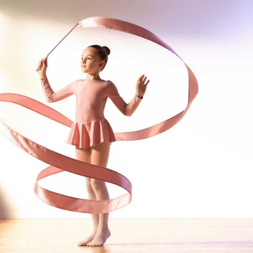 A girl mid-routine with a ribbon